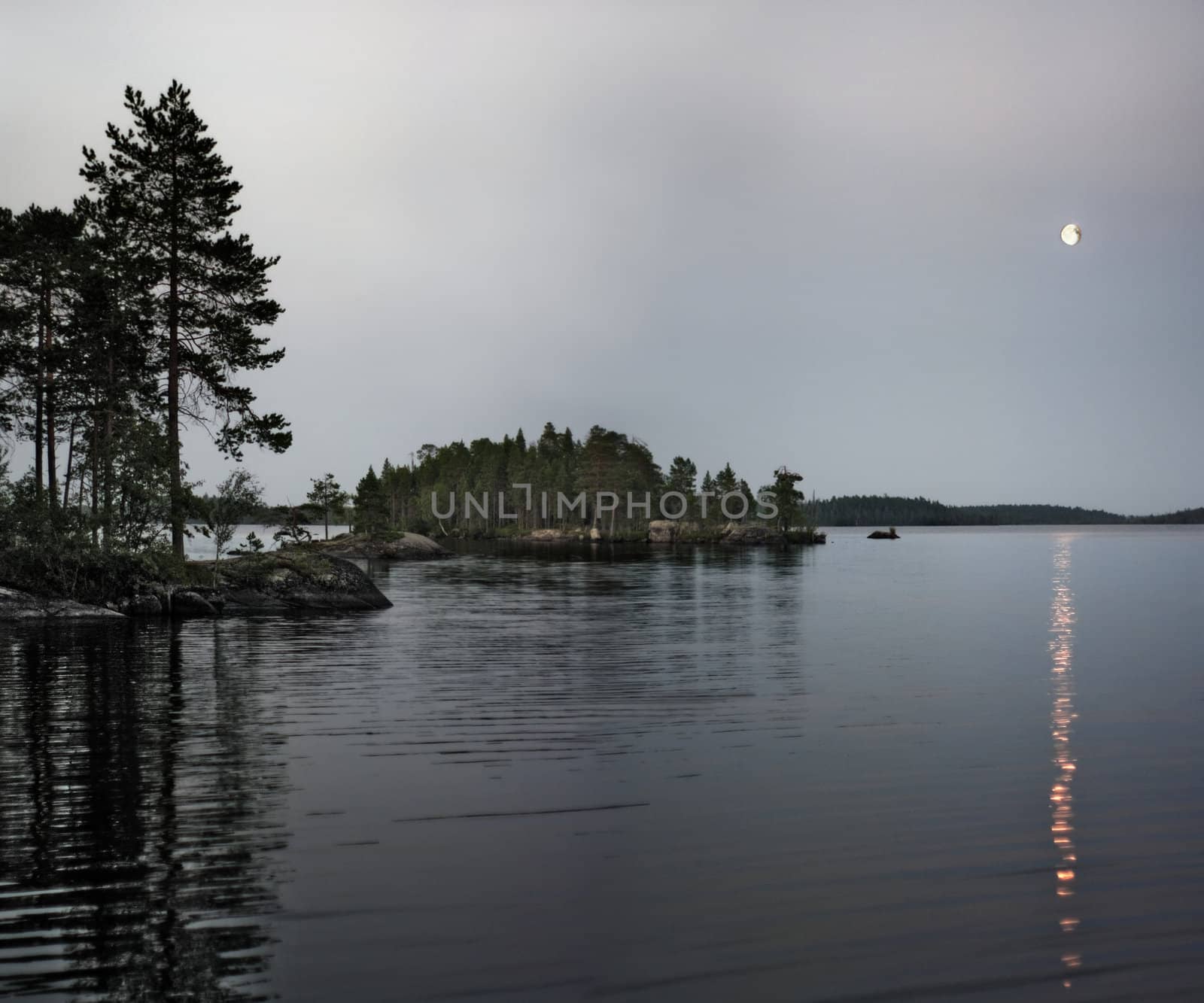 The moon and its reflexion over northern lake