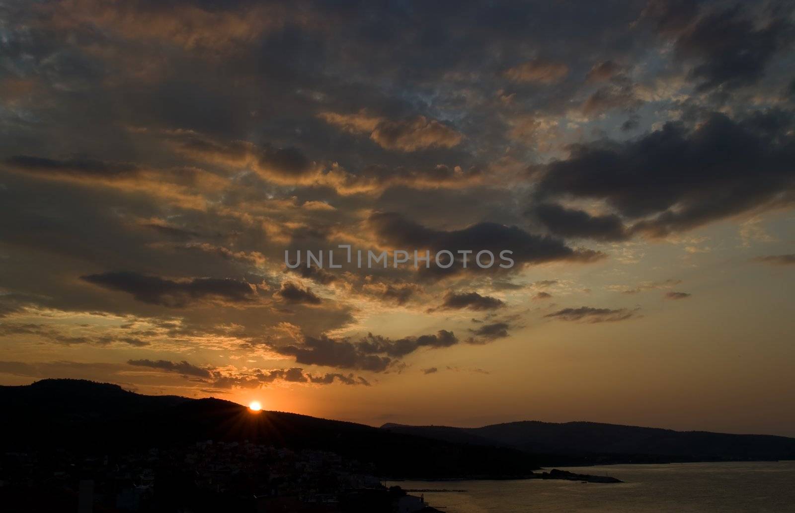 Sunrise and colorful clouds in Limenaria on Thasos Island, Greece.