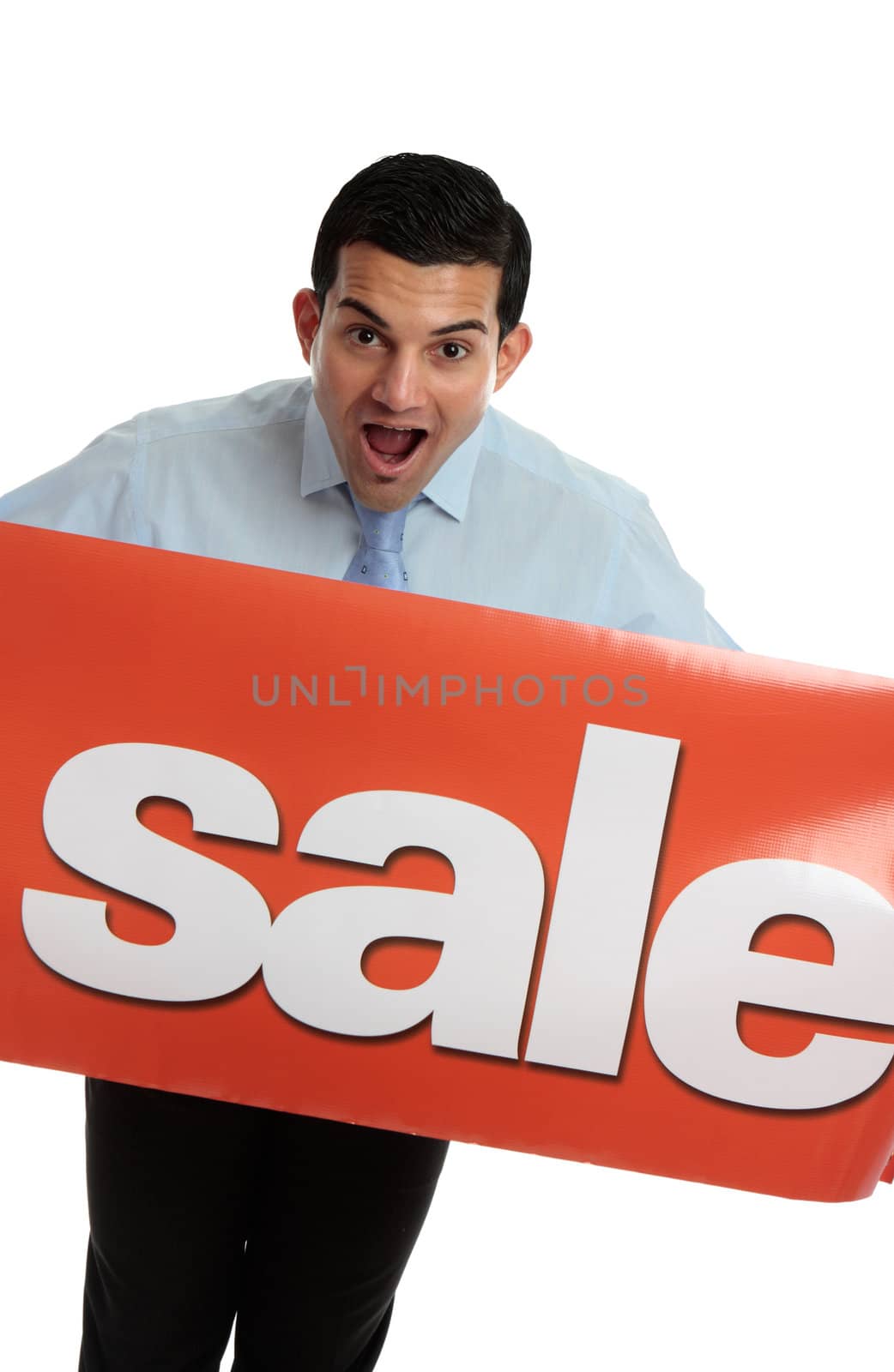 A closeup of an excited business or retail worker holding a red banner sign with Sale written on it.