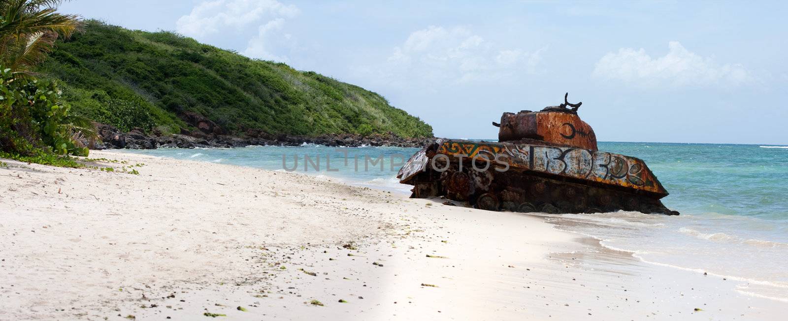 An old rusted and deserted army tank of Flamenco beach on the Puerto Rican island of Culebra. Paradise lost.