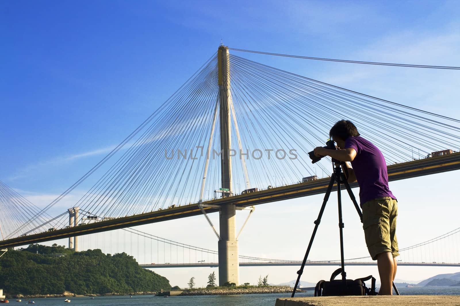 man take photo of the bridge at day