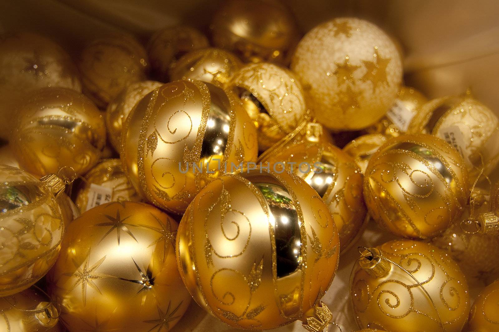 Many yellow christmas balls one on others