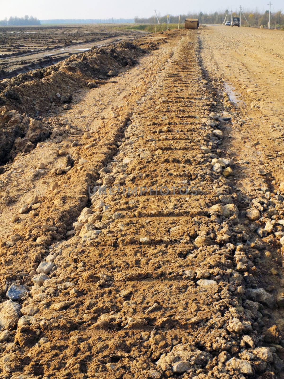 Trace from the building technics on a ground of constructed road