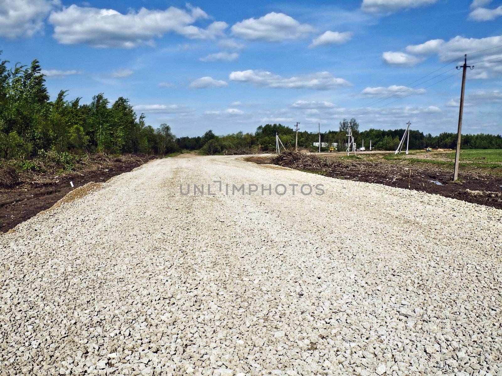 Road covered with a small stone before laying of an asphalt covering