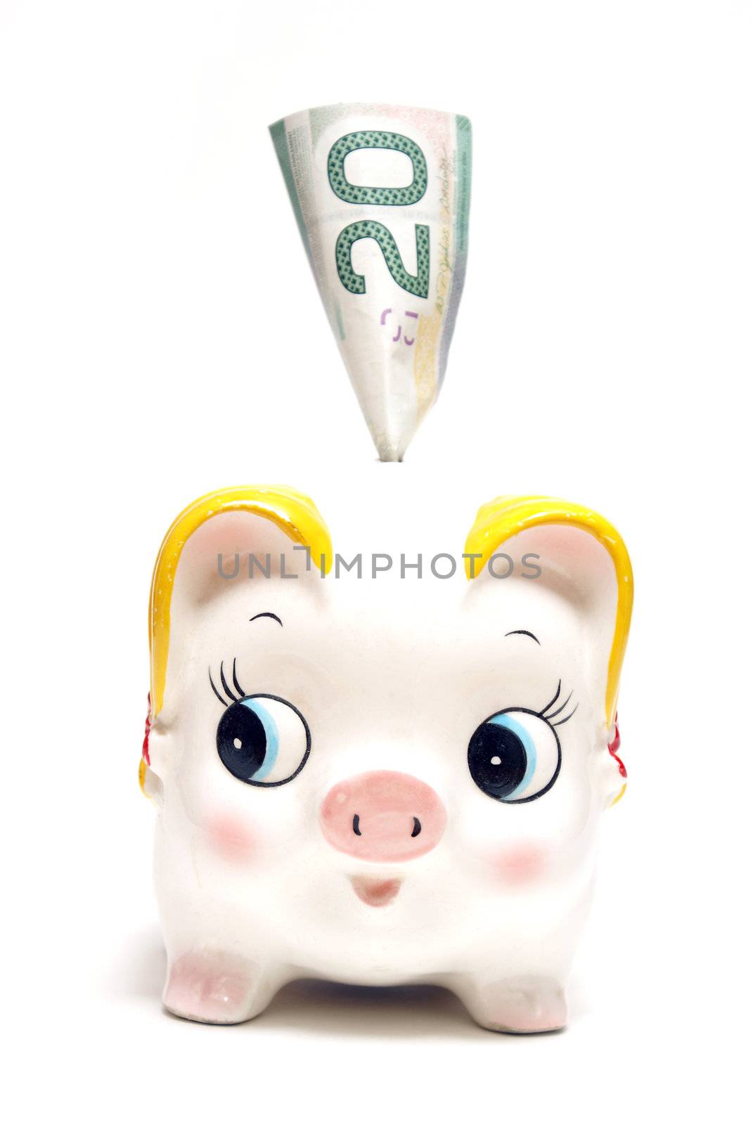 A piggy bank with a twenty dollar bill for the money saving mind set.