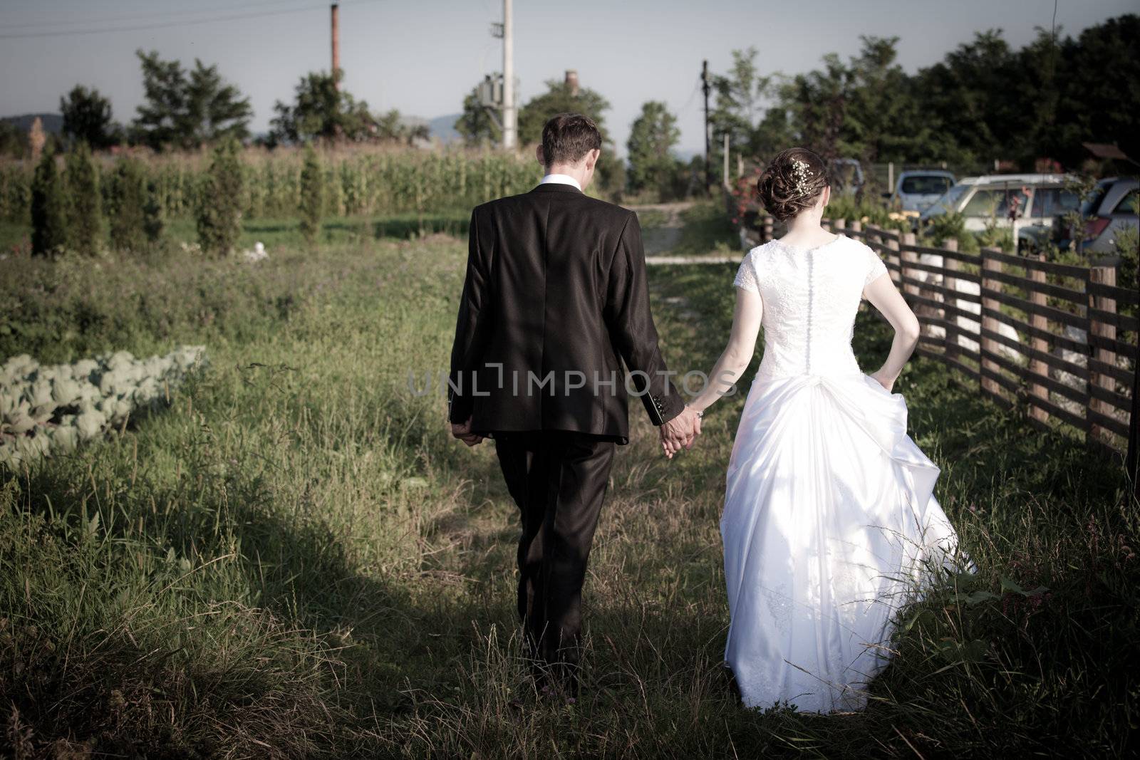 Young married couple walking on a countryside trail