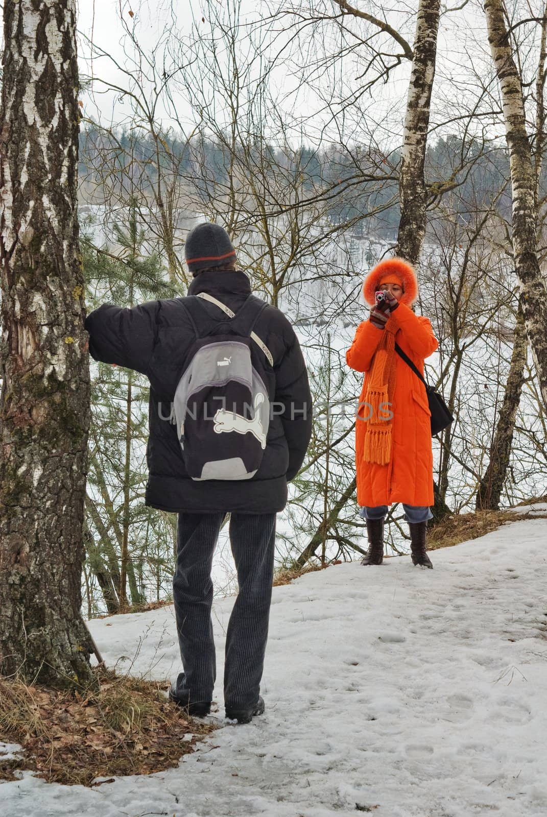 Family photo in the spring forest on the  lake coast