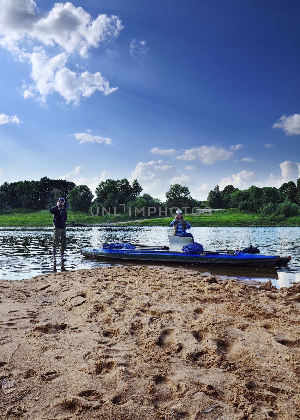 man and women talking on river beach