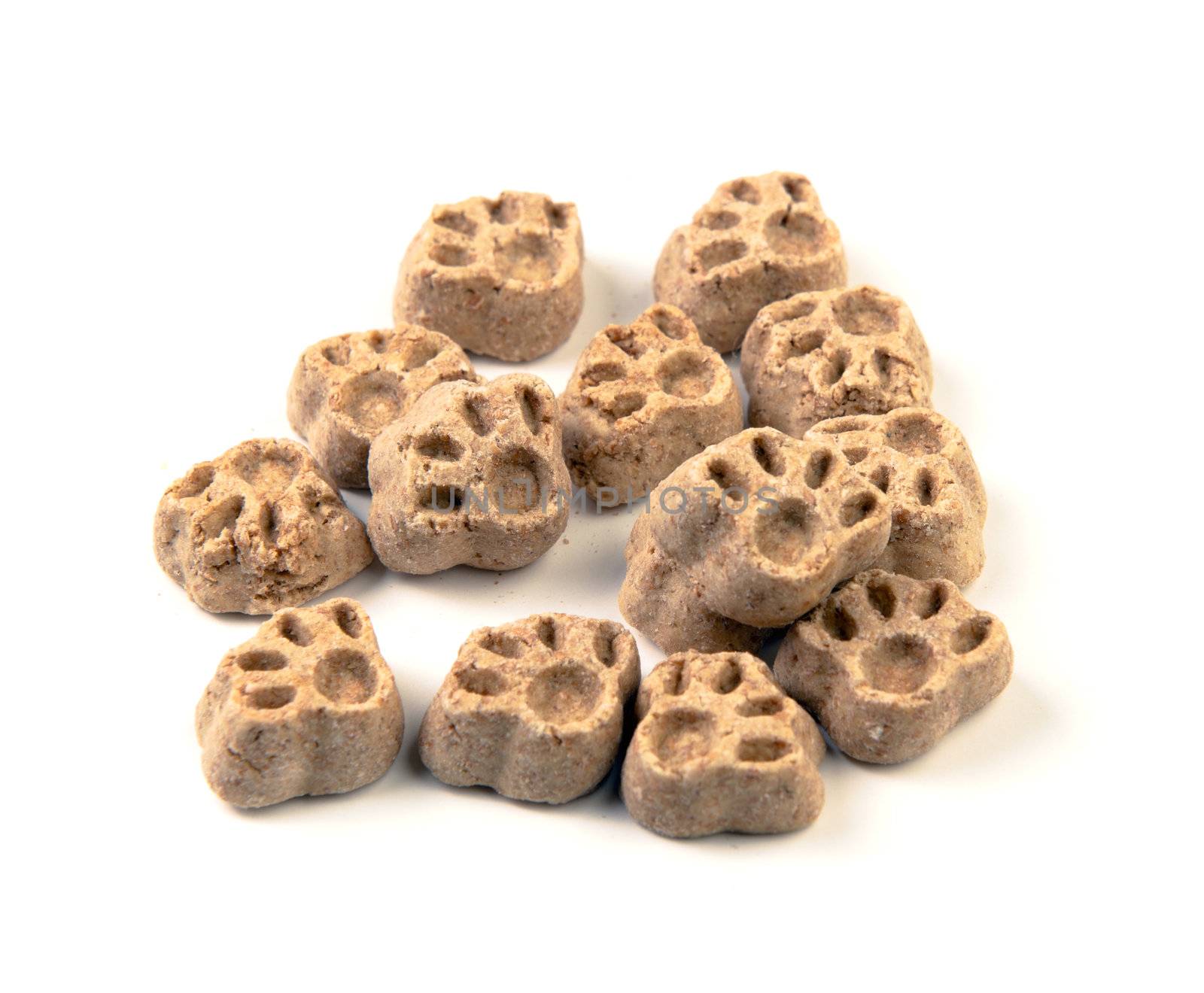 A small pile of dog treats in the form of paws, shot on a white background.