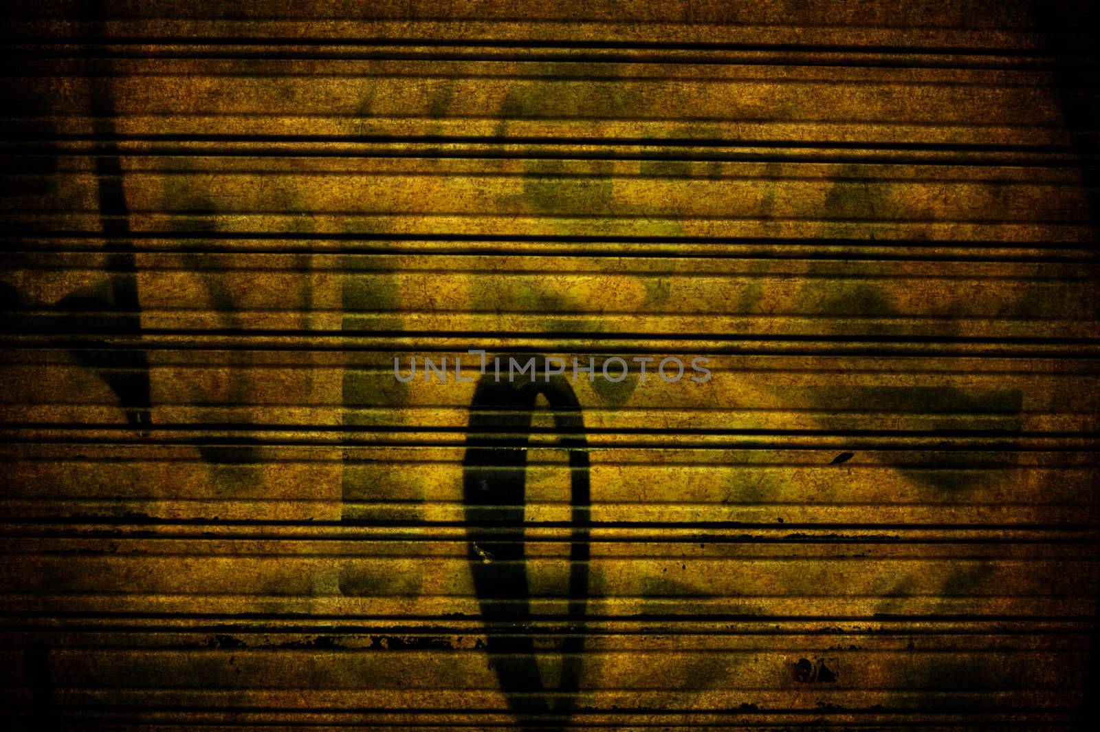 A grunge old rusted yellow metal shutter