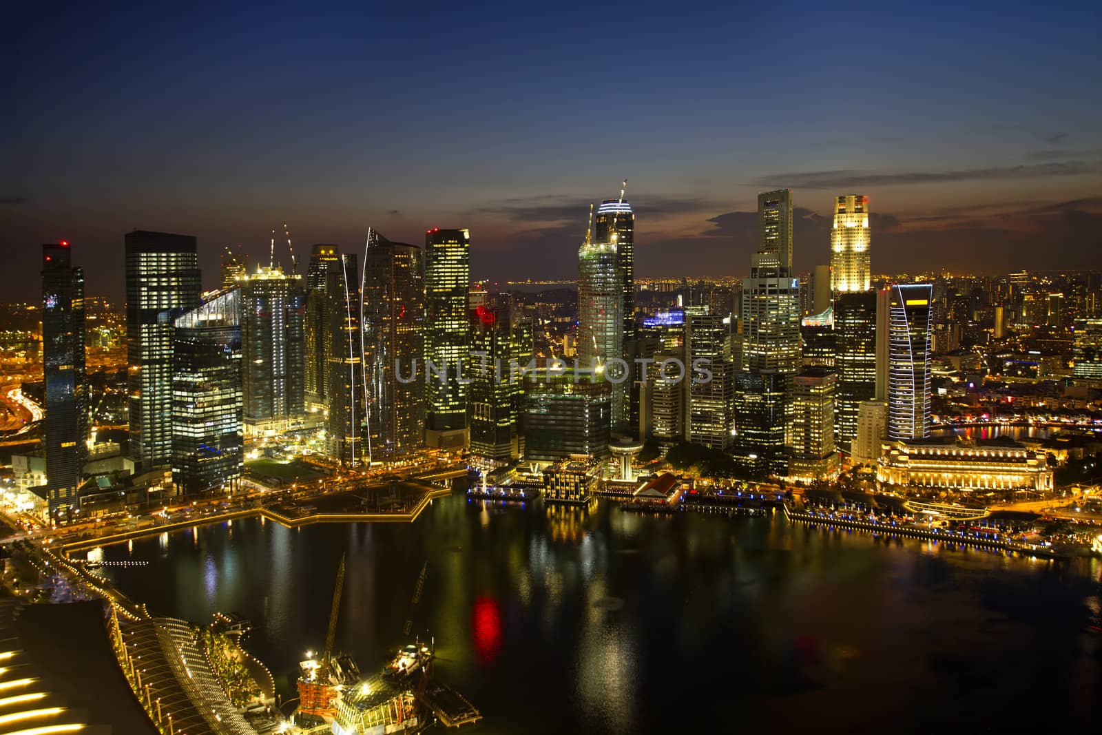 Singapore City Skyline by River at Dusk Aerial View