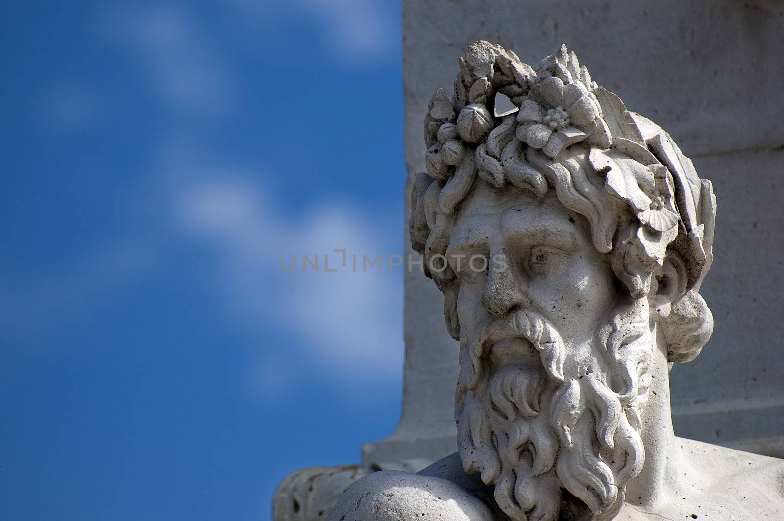 A marble head and a blue sky on background