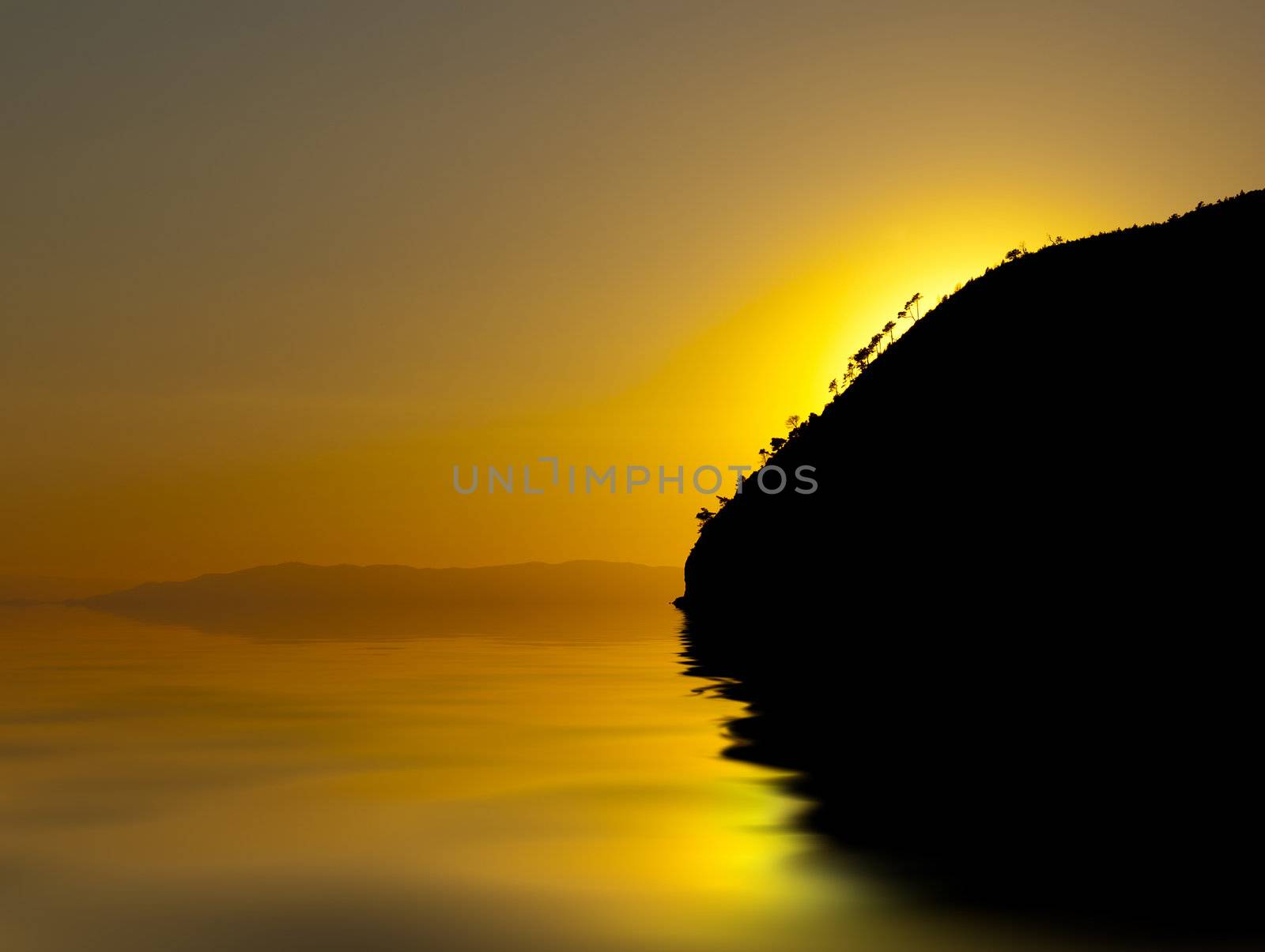 An orange and yellow sunset over a calm sea