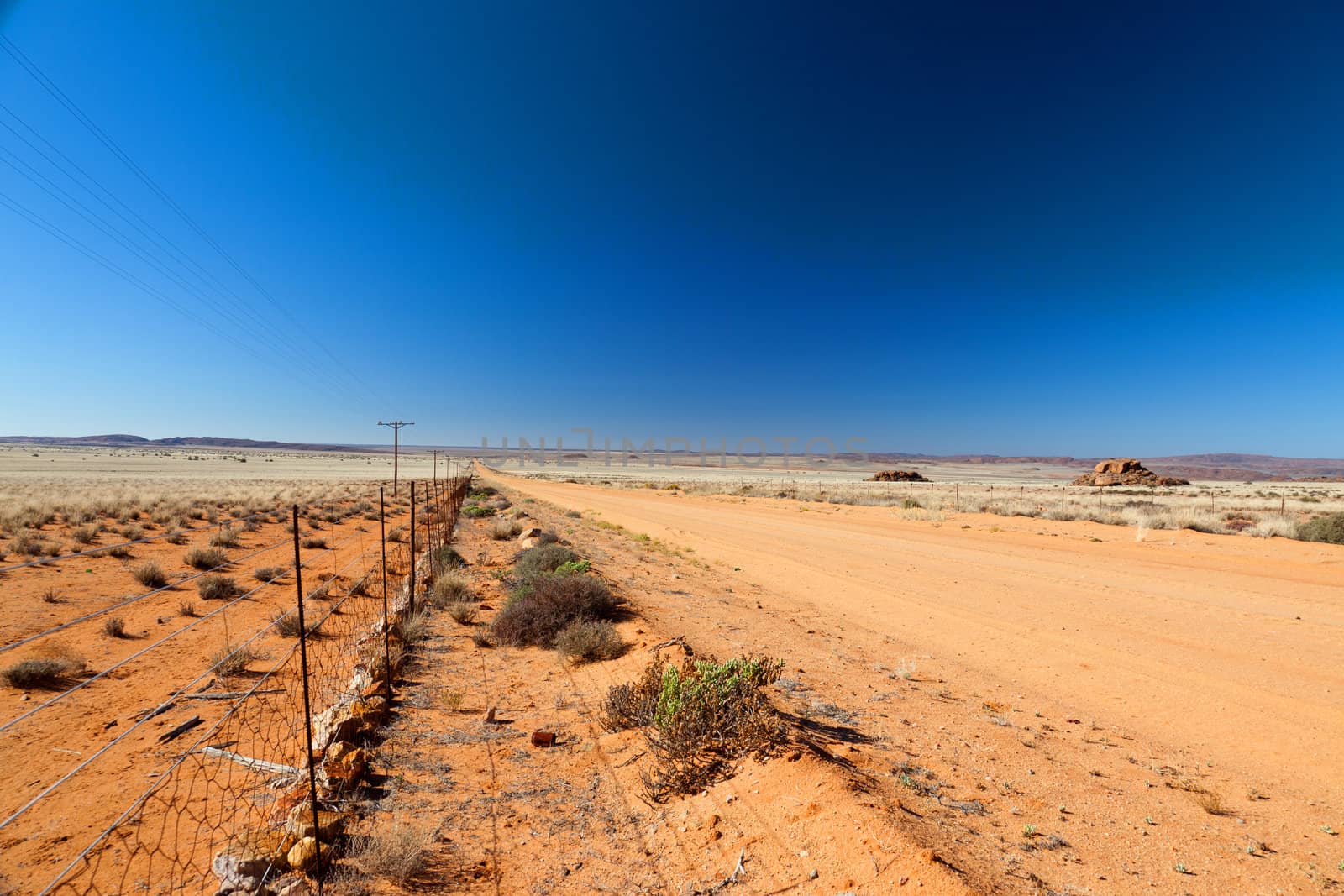 Road through a vast, arid landscape - horizontal by Farina6000