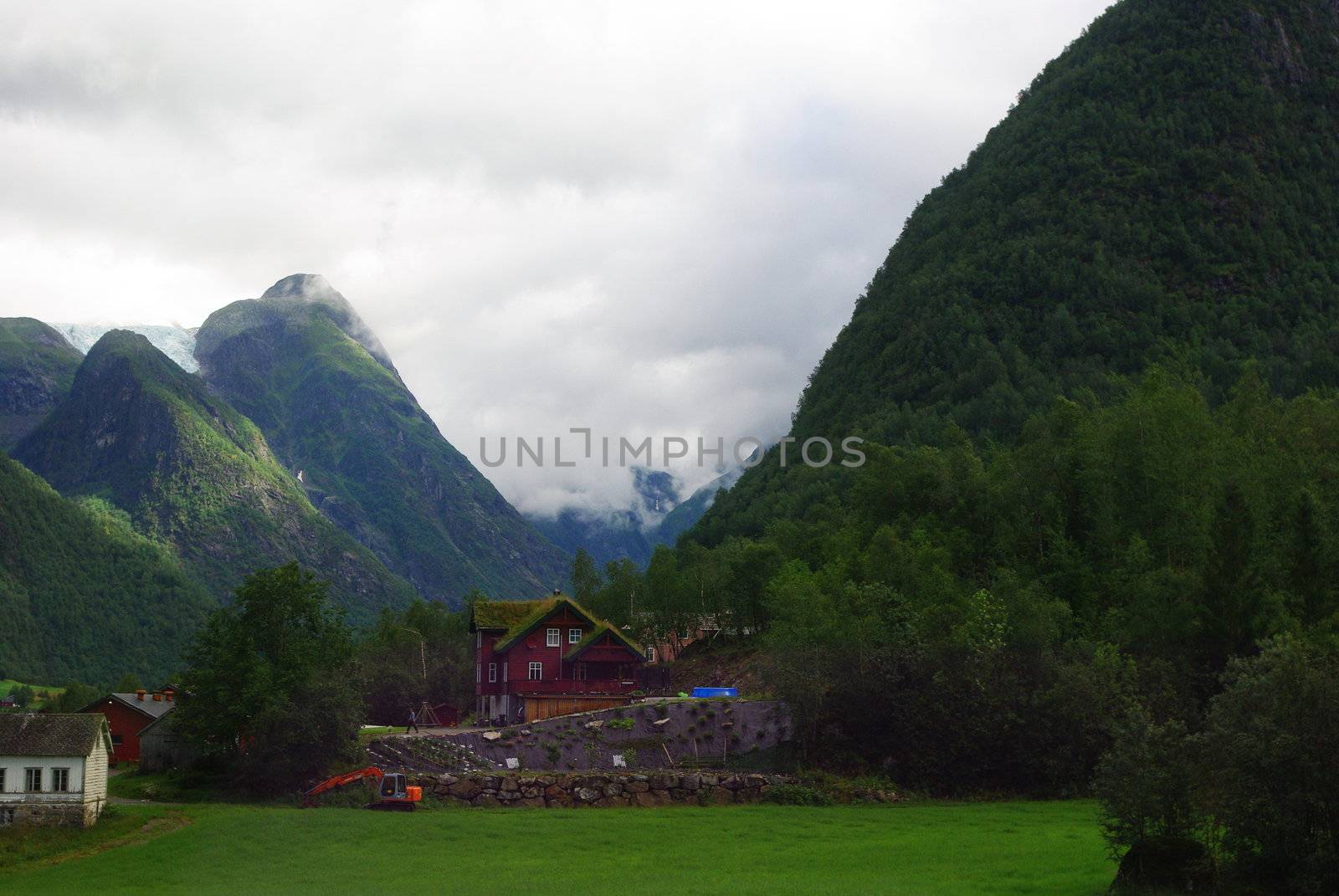 Traditional wooden houses on hillside background in Invik, Norway