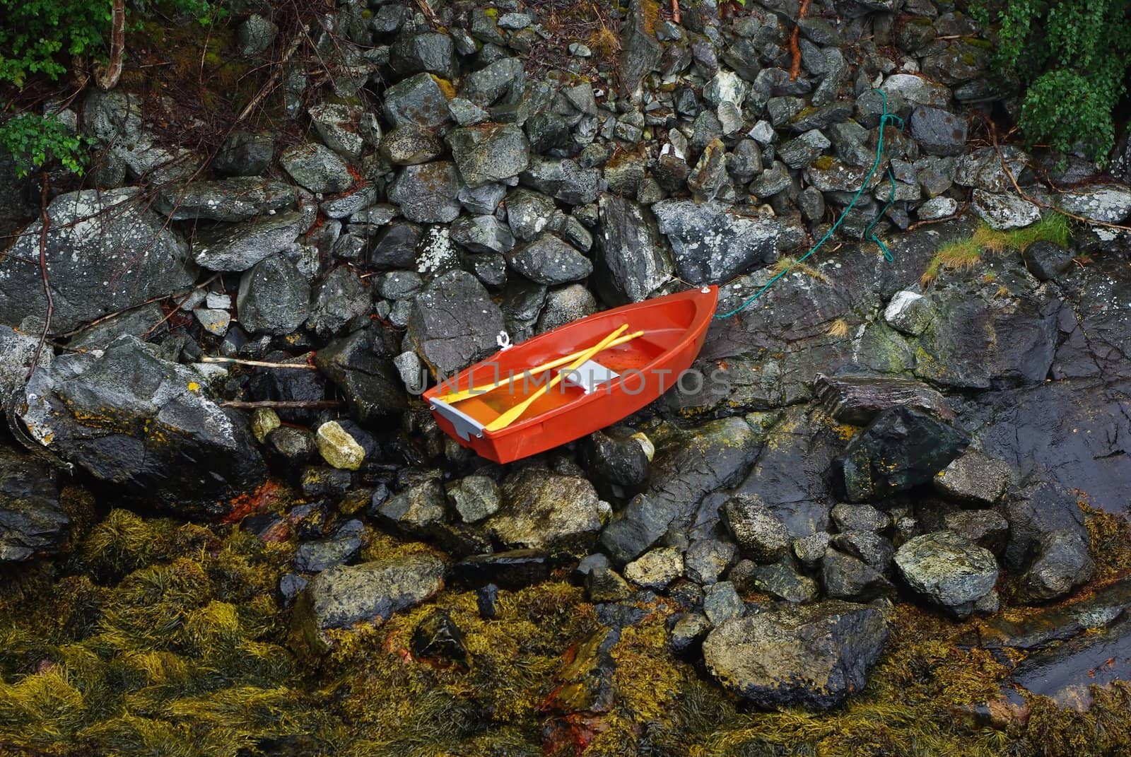 Little boat on the ocean coast during low tide