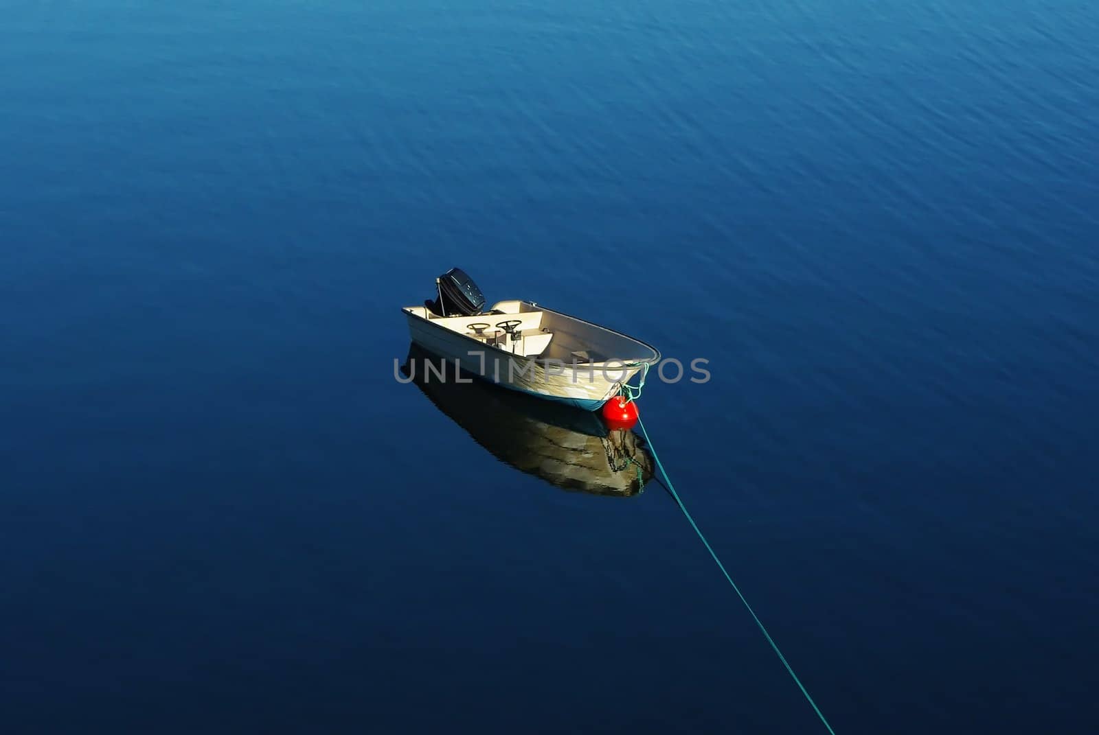 Single boat floating on the calm sea surface