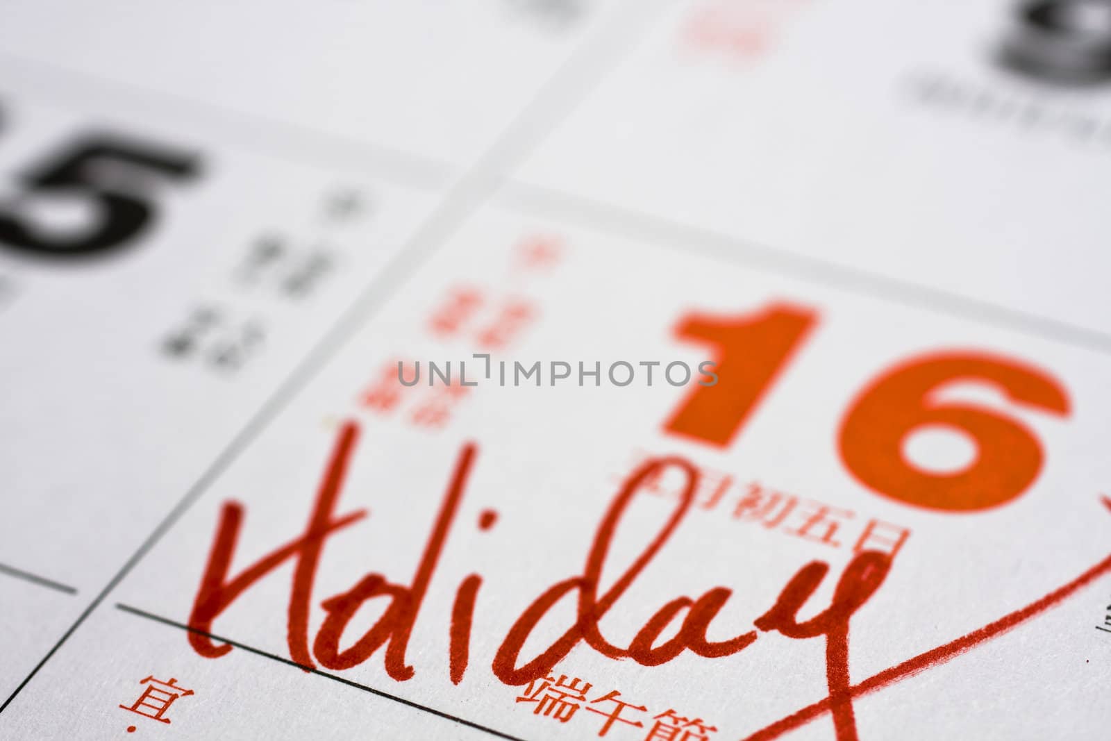 Hand writing holiday important date on calendar