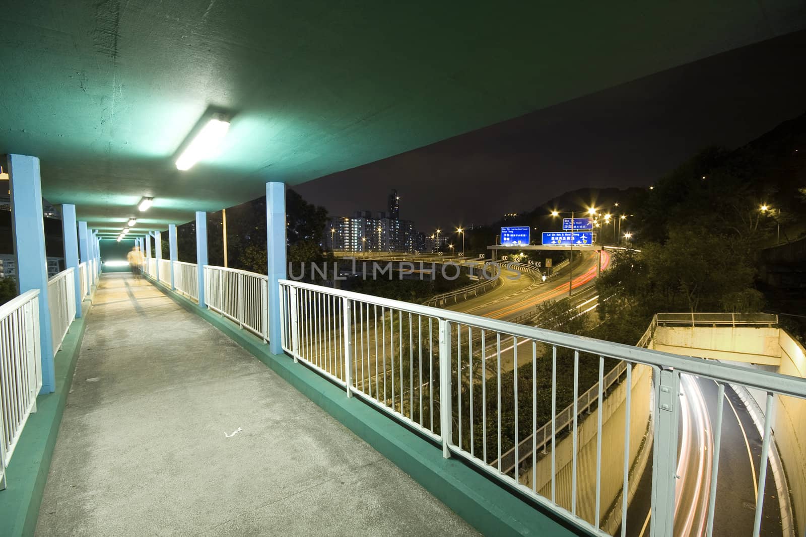 view on footbridge of modern urban city with Freeway Traffic at Night, hong kong