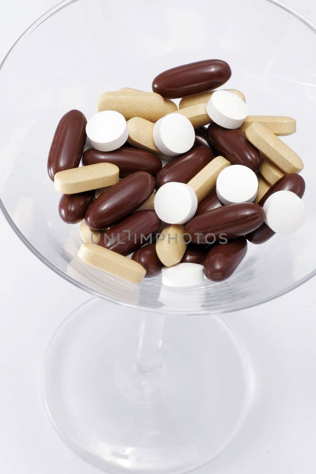 Deadly Cocktail - A Martini Glass Filled With A Mixture Of Pills- White Background