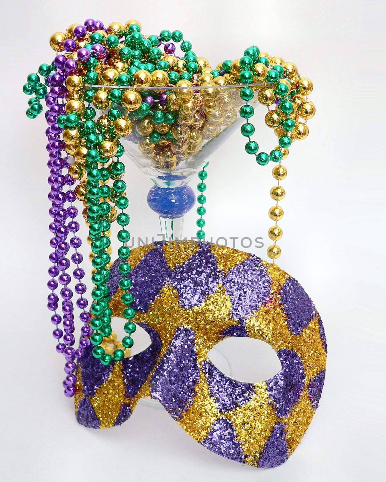Harlequin mask and mardis gras beads