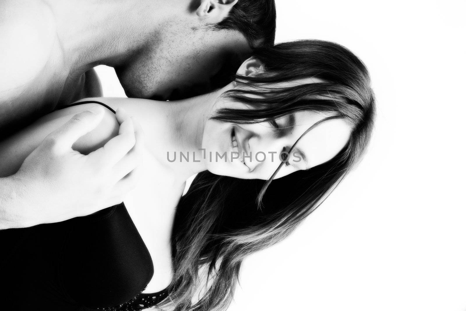 Young adult couple in the studio kissing