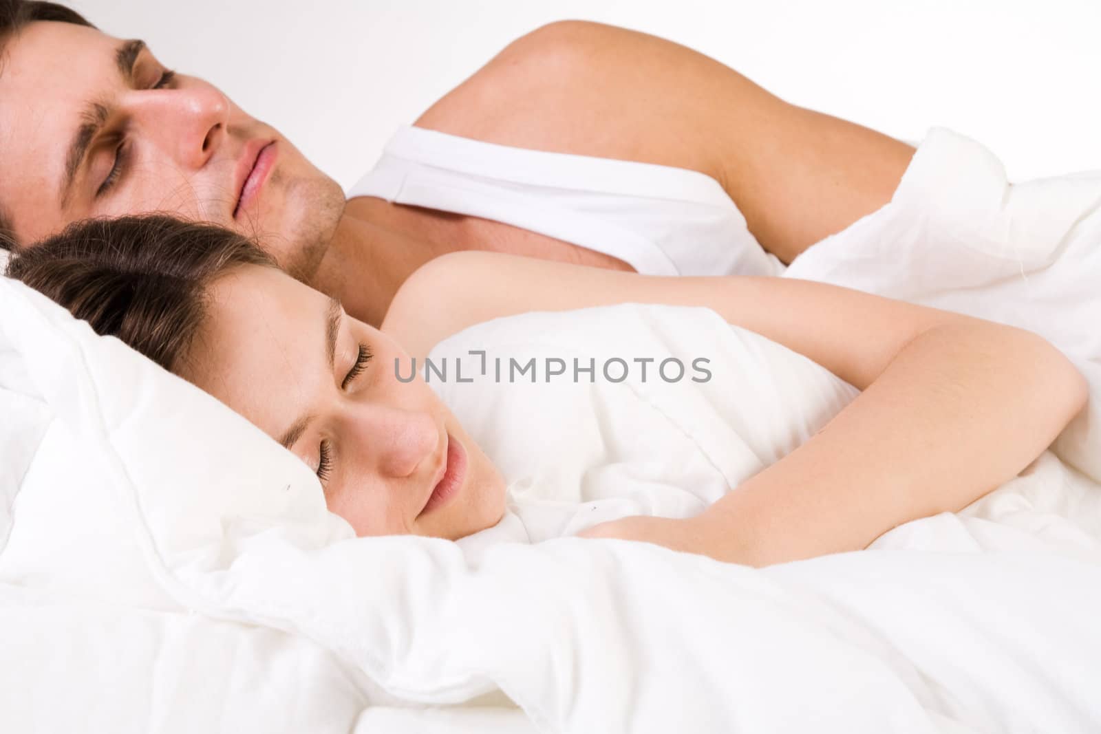 Young adult couple in the studio sleeping