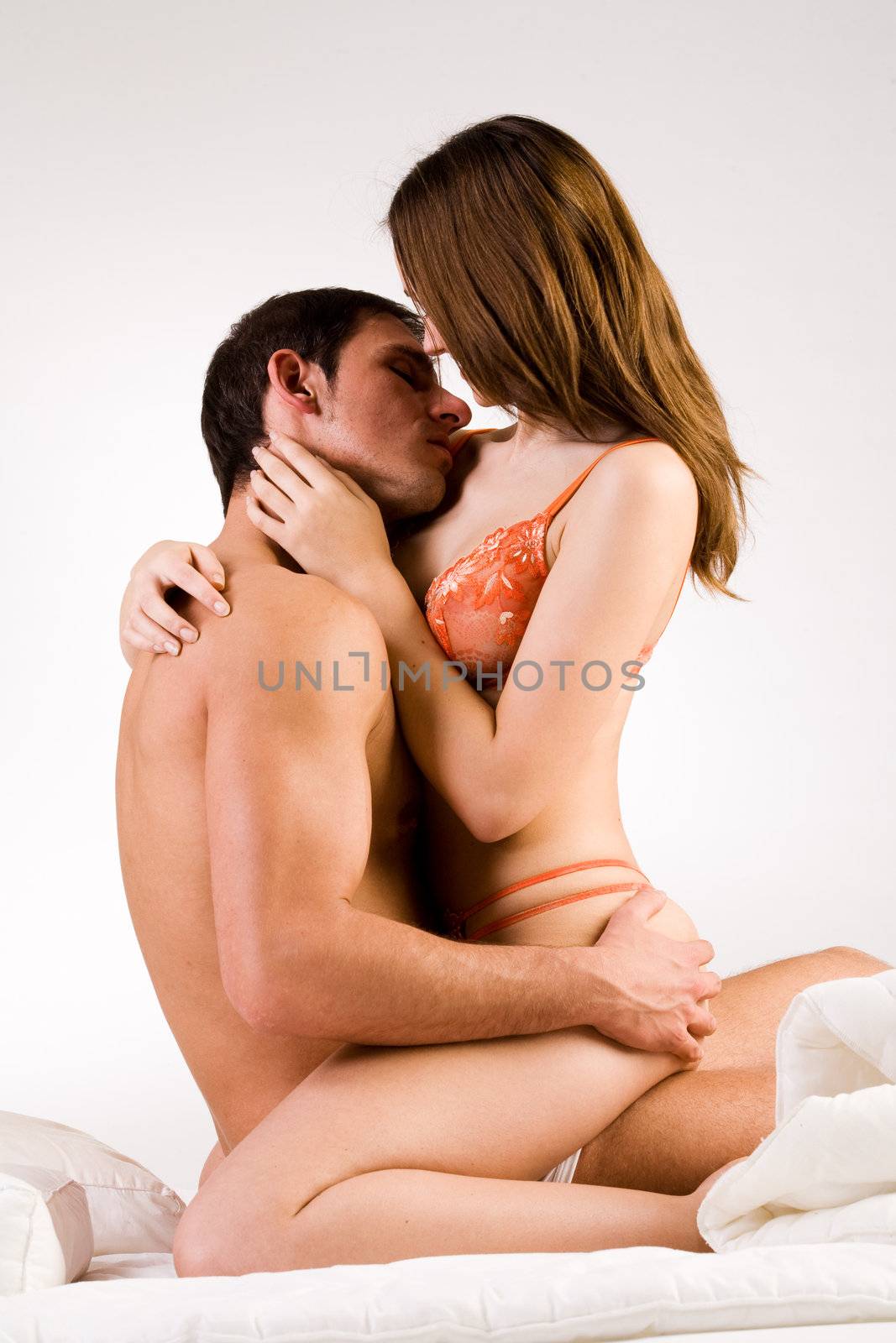 Young adult couple in the studio hugging