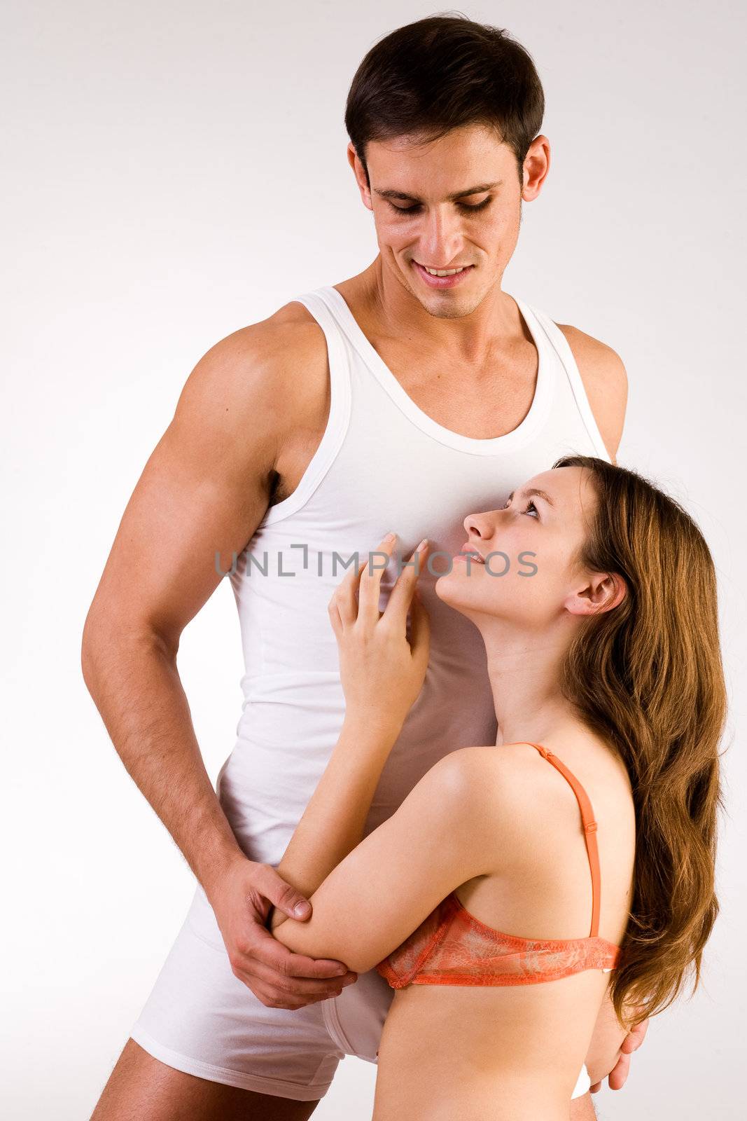 Young adult couple in the studio on a bed