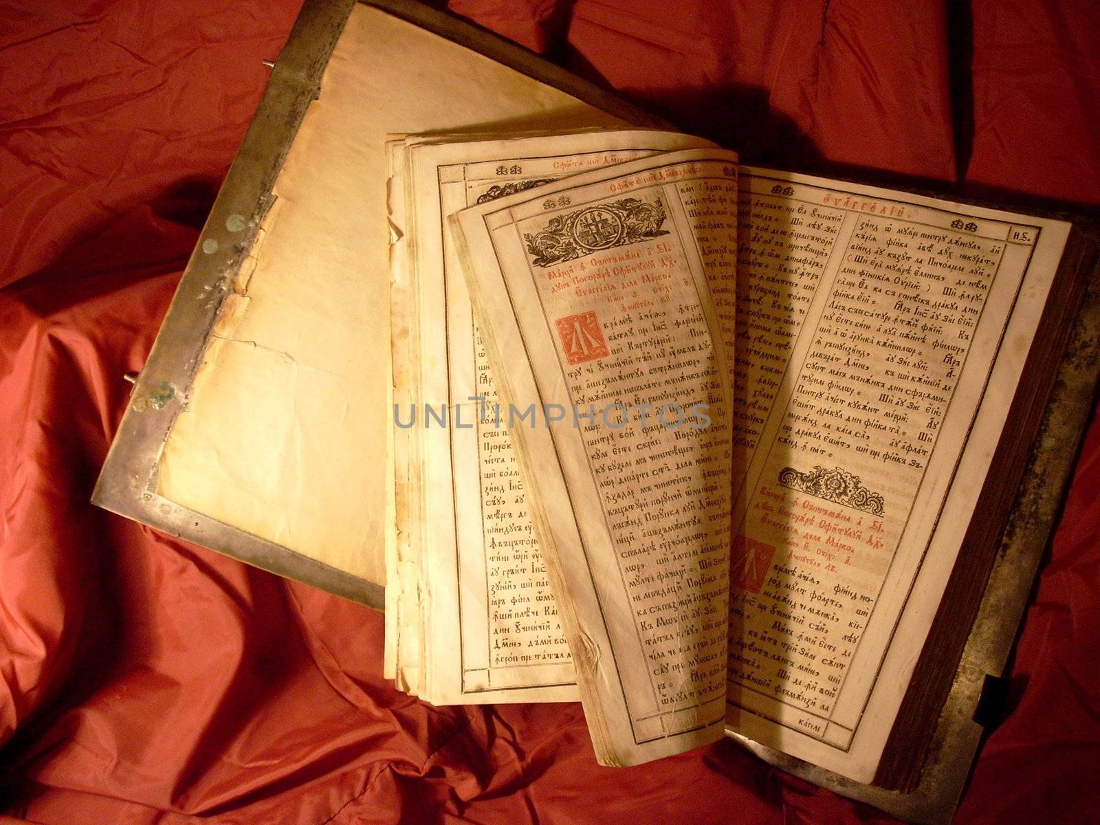 very old Bible on a red shining silk background