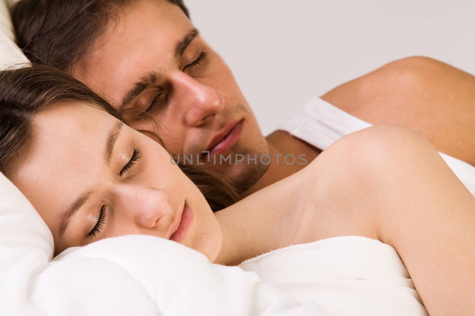 Young adult couple in the studio sleeping