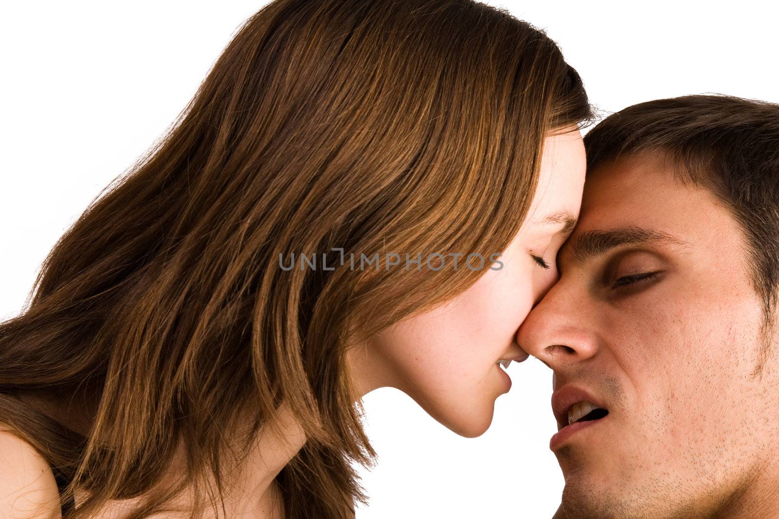 Young adult couple in the studio kissing