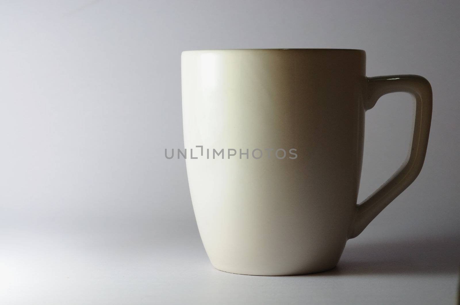 white ceramic cup by ekawatchaow