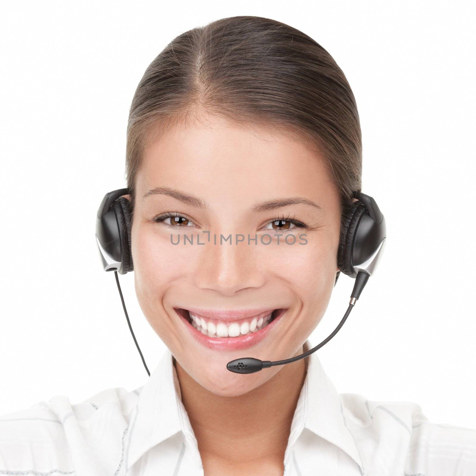 Headset woman from call center. Portrait close-up of young smiling woman from call center wearing headset. Isolated on white background. Mixed Asian / Caucasian woman