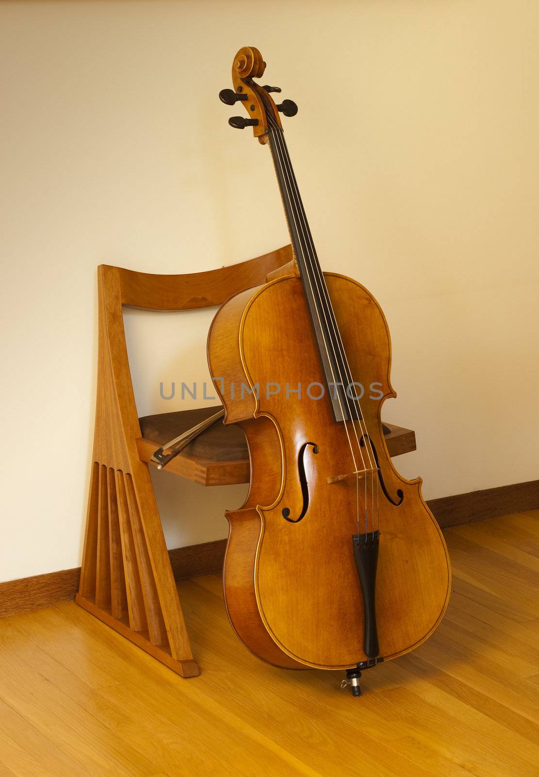 cello or violincello resting against chair