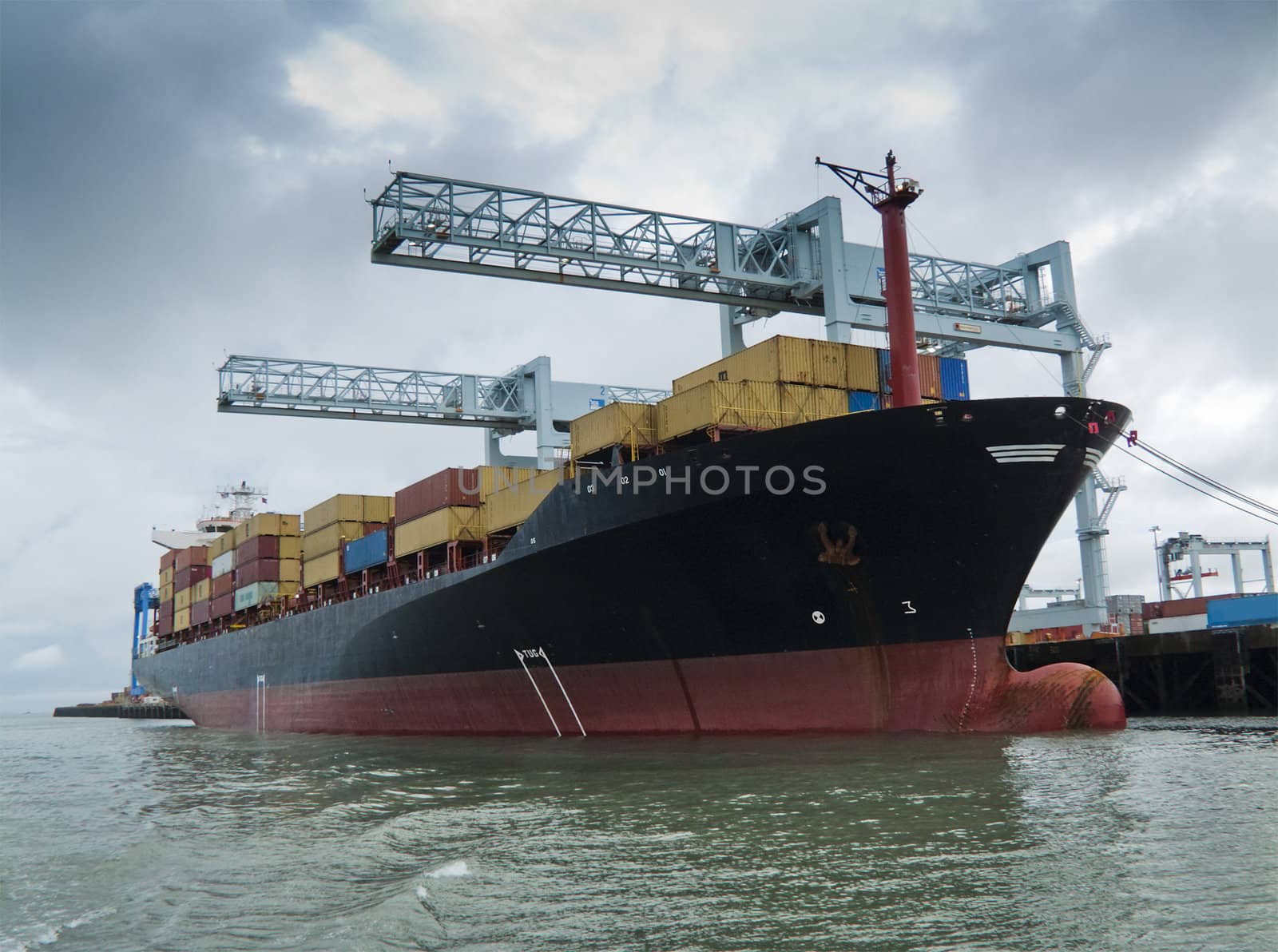 Container ship being loaded in harbor