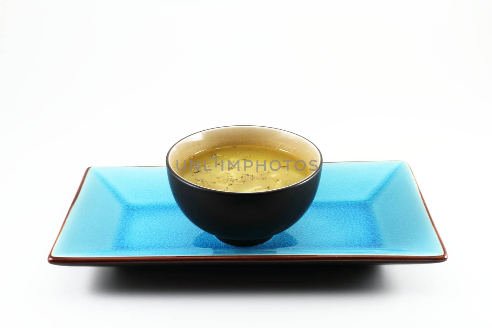 Traditional oriental Tabe Setting with a blue tray and a bowl of soup.