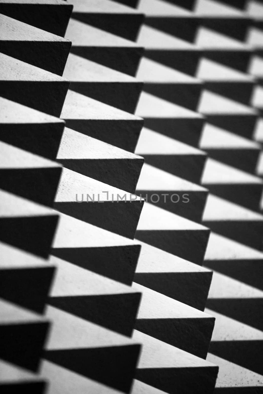 Abstract closeup view of a spiked wall in black and white.