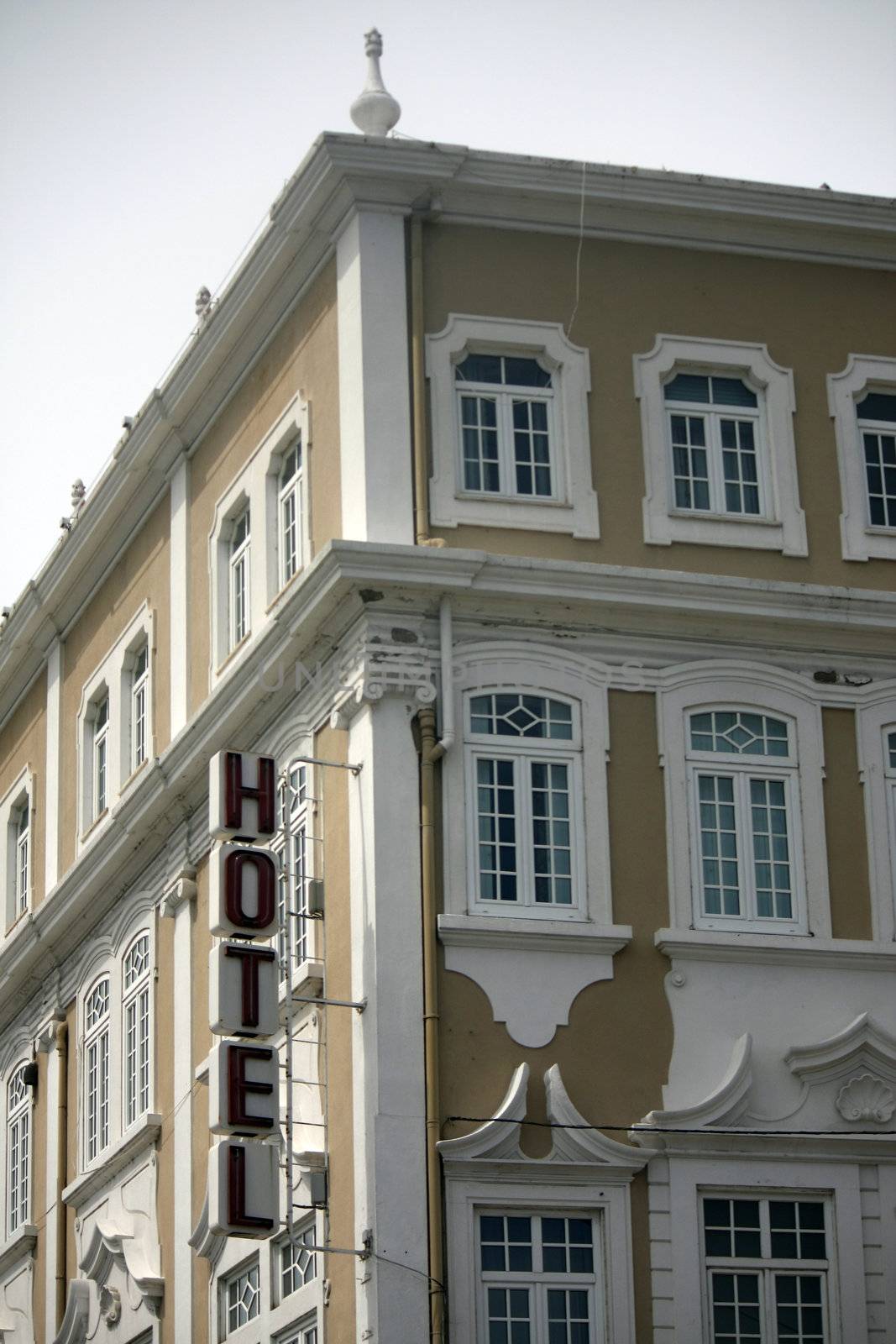 Partial view of a hotel building with sign on a city.