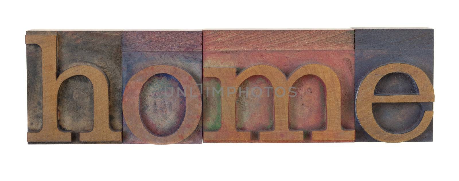 home - word in vintage letterpress printing blocks, stained by color inks, isolated on white