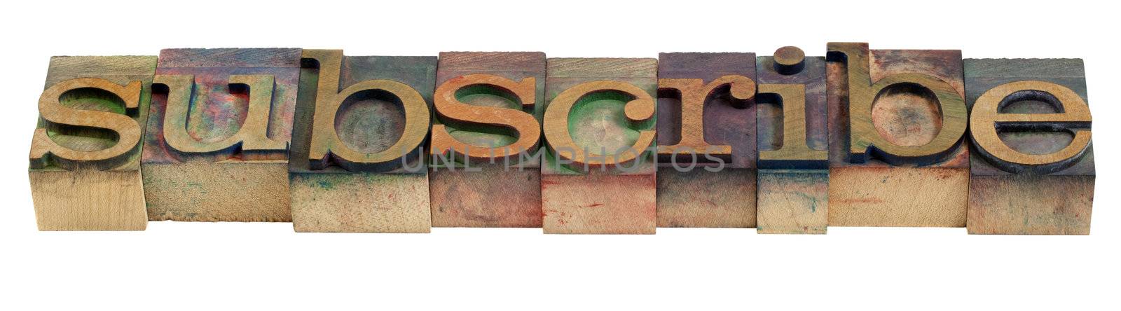 subscribe word in vintage wooden letterpress printing blocks stained by color inks