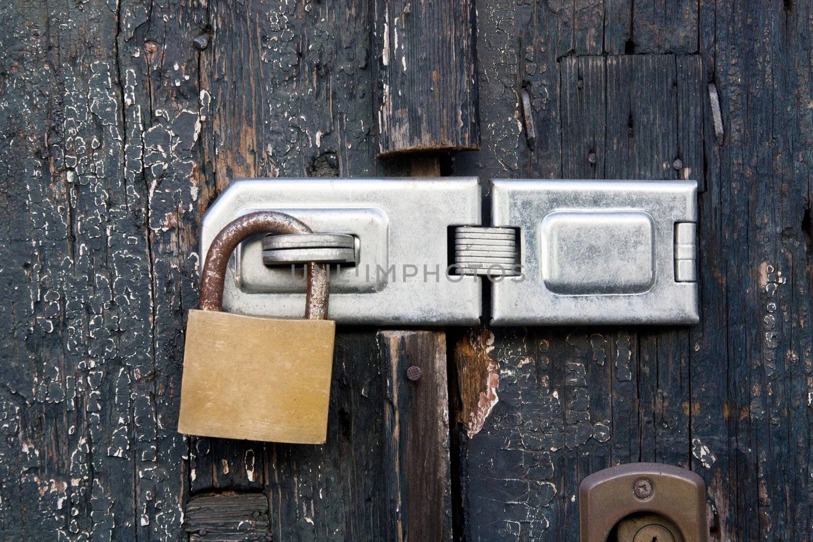 Close up view of a lock on old wooden door.