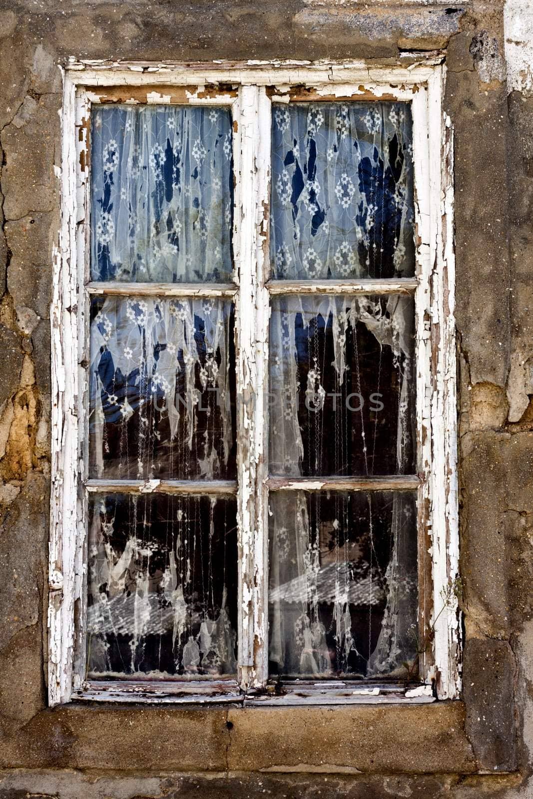 Close up view of an extremely old window from a decaying house.