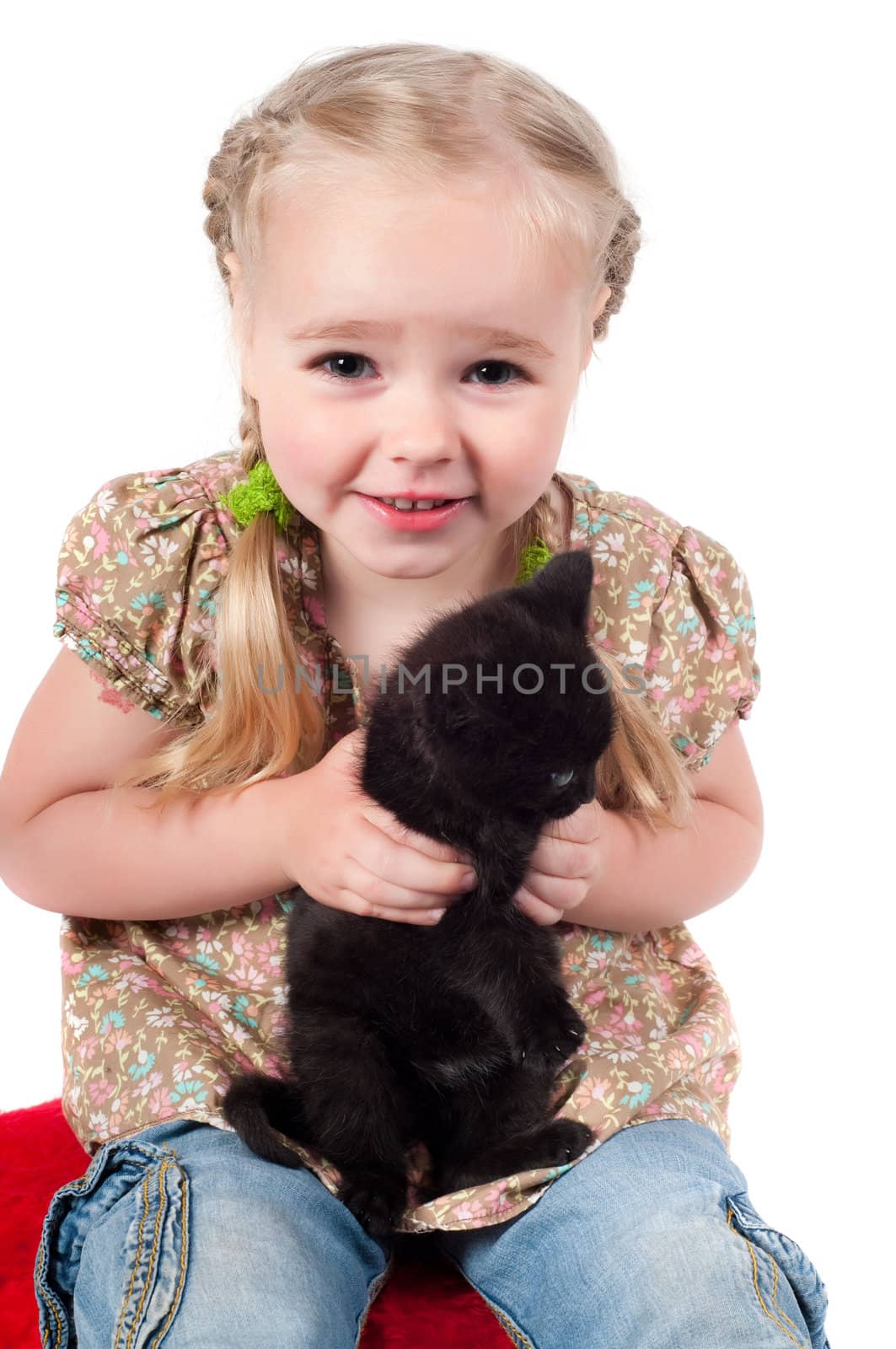 Shot of little girl playing with kitten