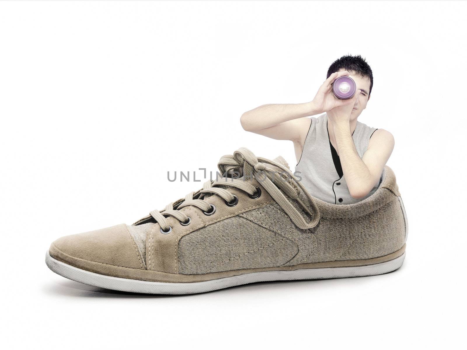 Concept with photographer going to make photos in a shoe