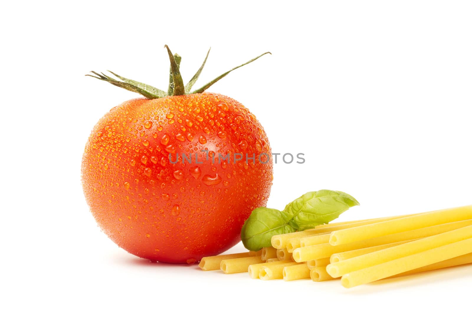 raw macaroni with basil and tomato on white background