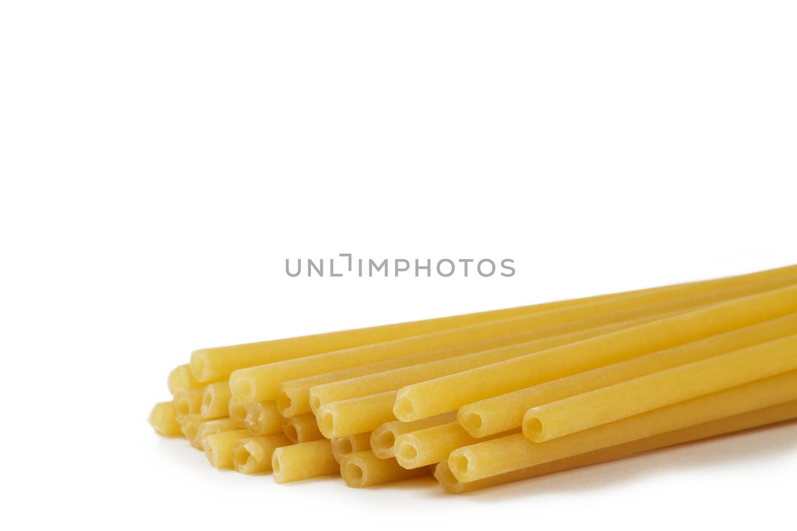 raw yellow macaroni isolated on white background