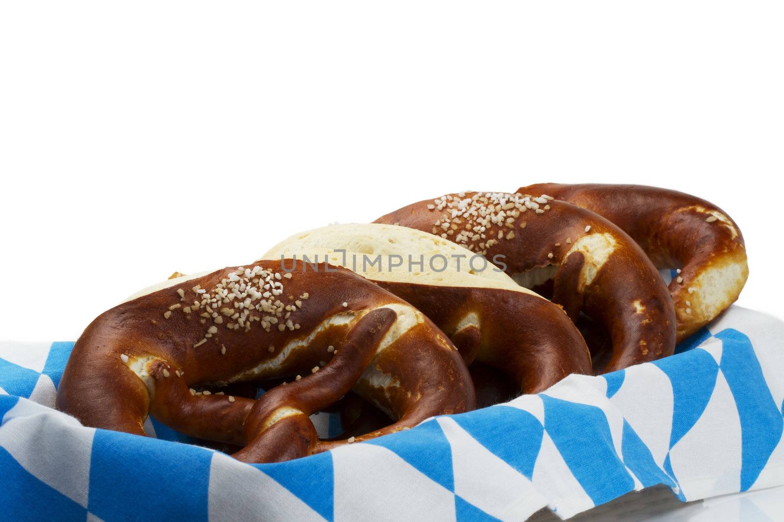 some pretzels in a bavarian bread basket on white background