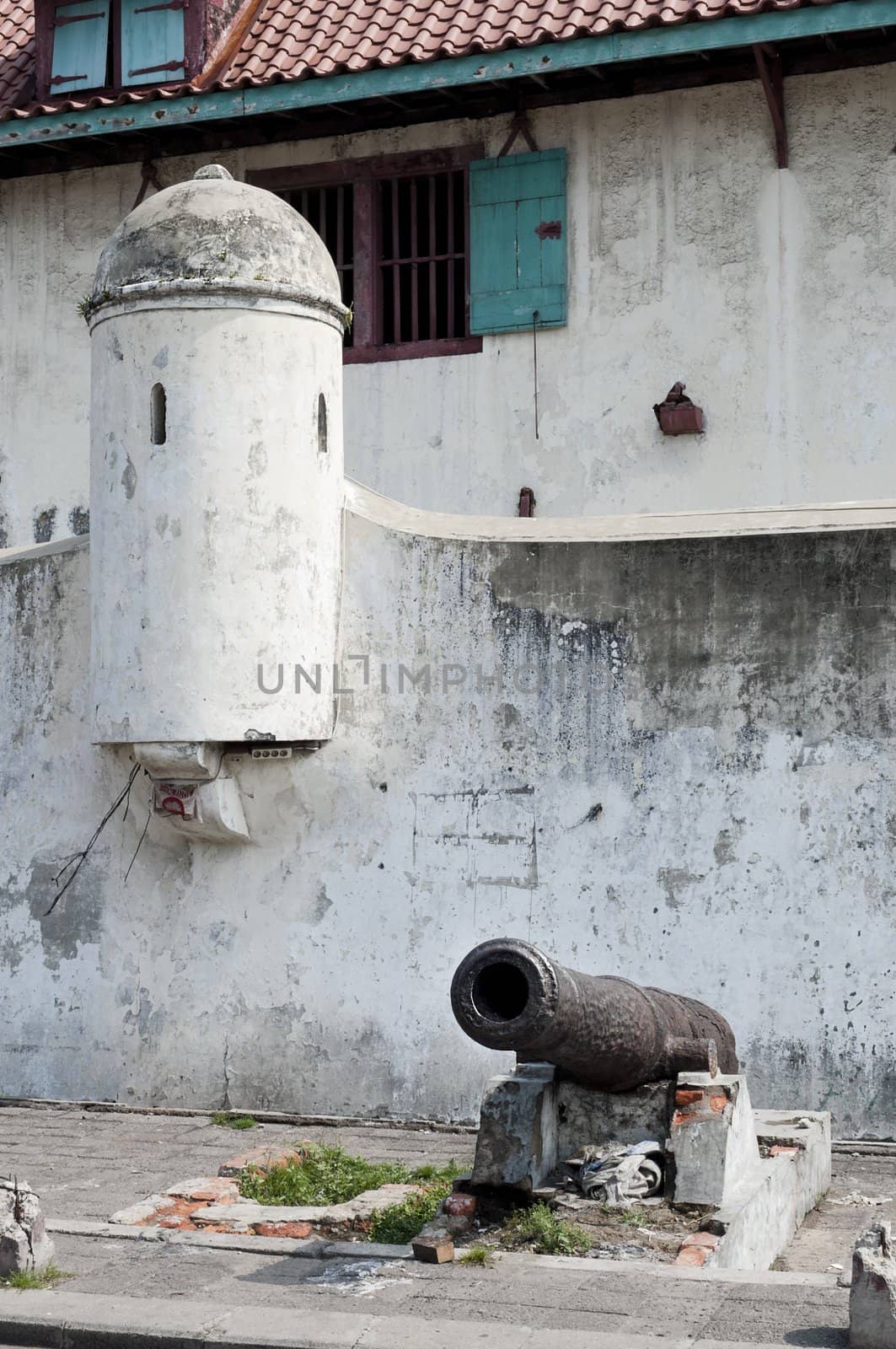 Historical cannon outside a fort wall in Jakarta