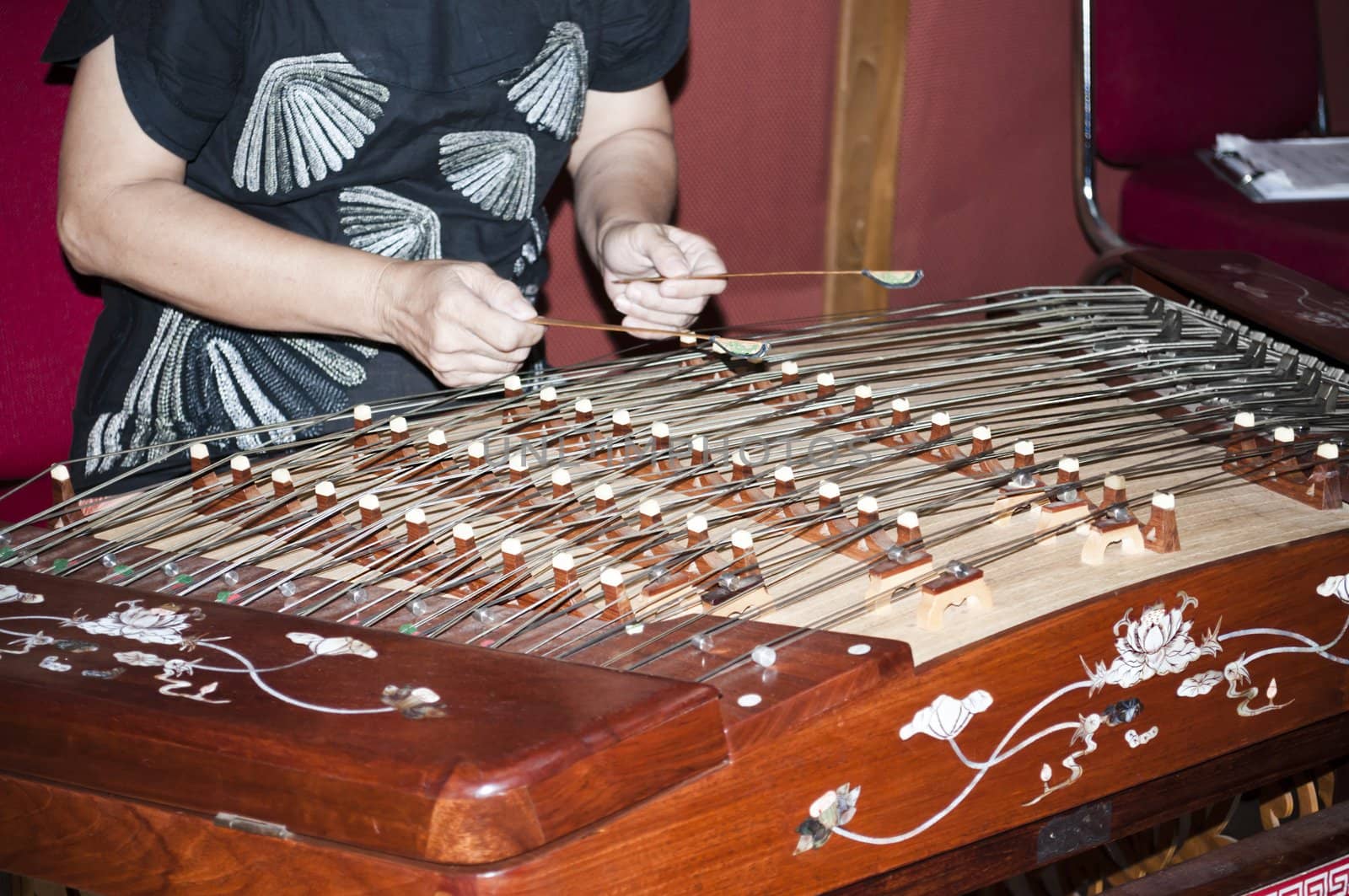 Wooden elegant hammered dulcimer khim played by indonesian musician